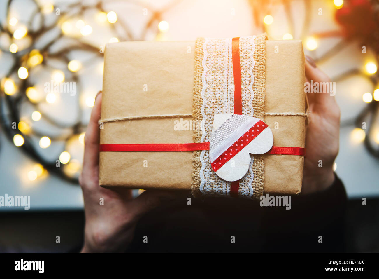 girl holding a Christmas gift in hand Stock Photo - Alamy