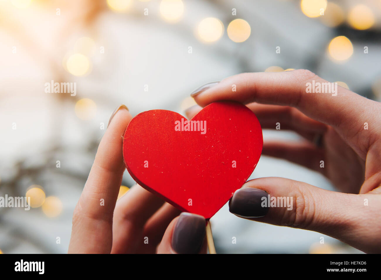 girl holding a red heart in the hands Stock Photo - Alamy