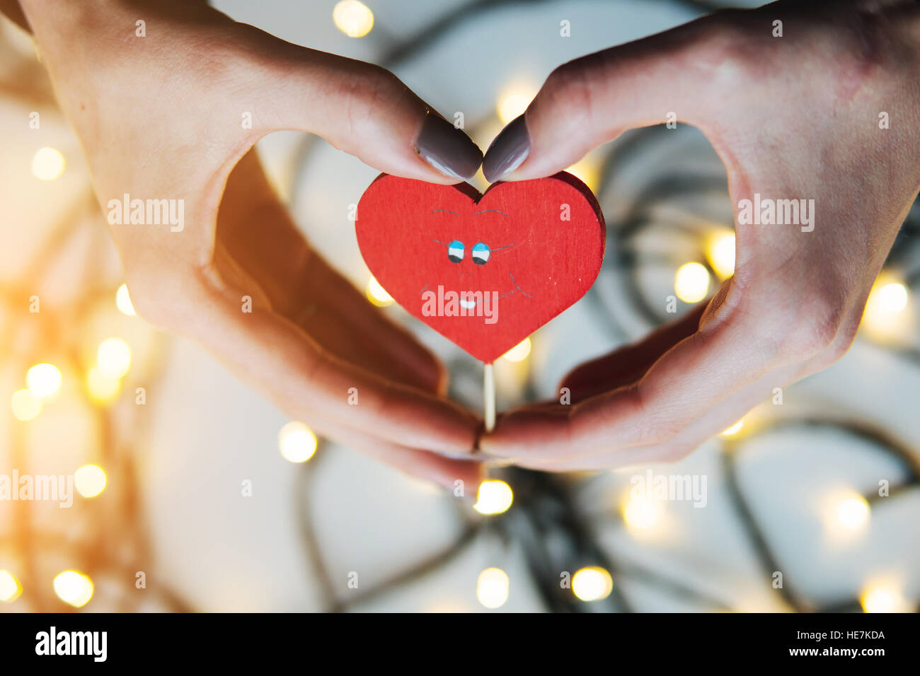 girl holding a red heart in the hands Stock Photo - Alamy