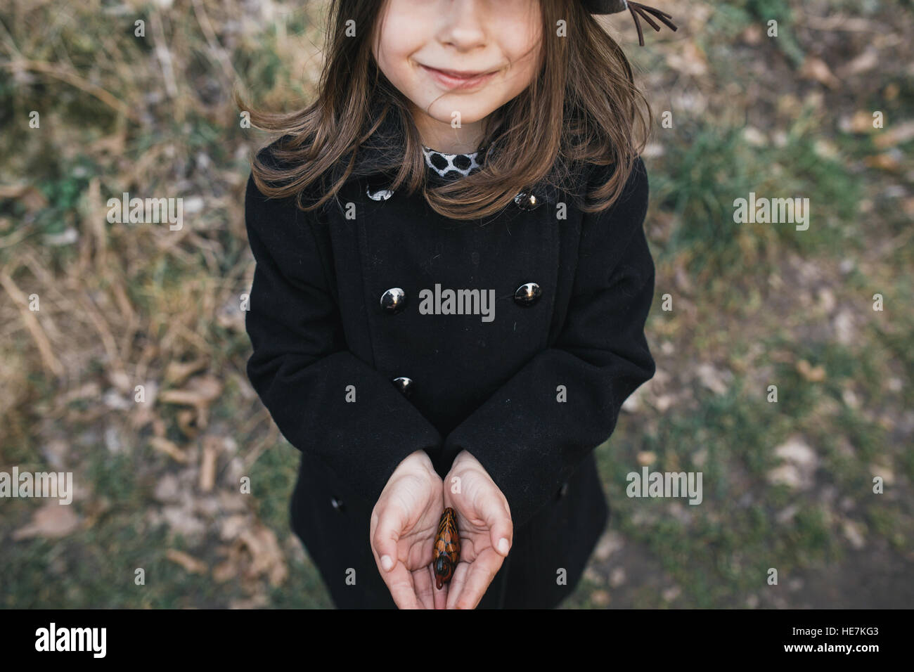 little girl in a black coat and hat Stock Photo Alamy