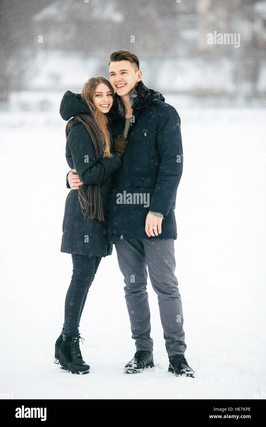 couple posing in a snowy park Stock Photo - Alamy