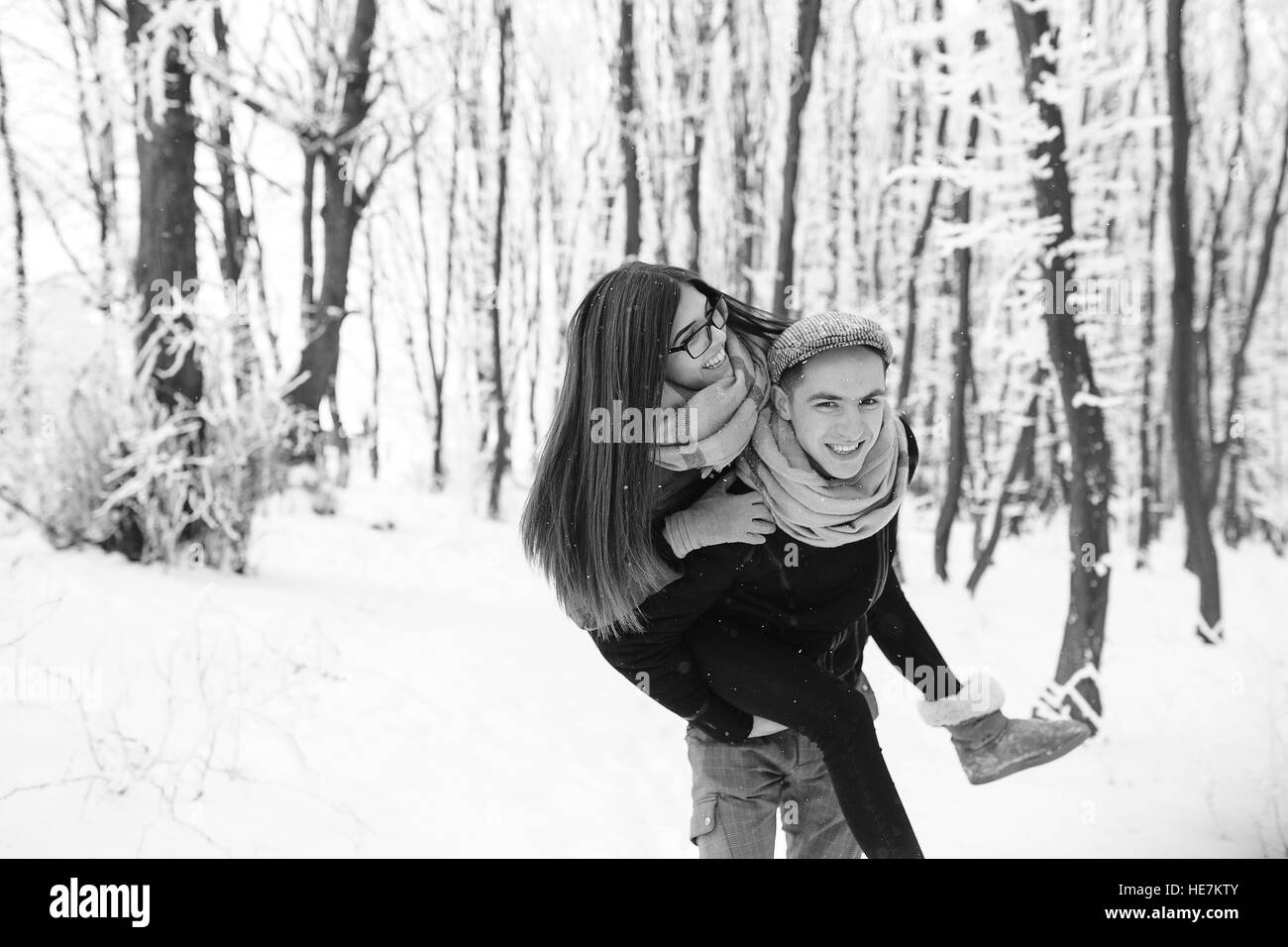 Happy couple playful together in snow park Stock Photo - Alamy