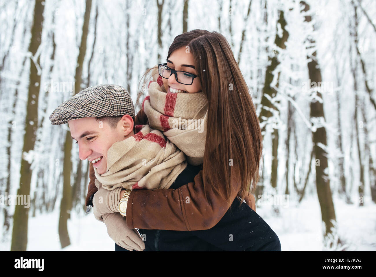 Happy couple playful together in snow park Stock Photo - Alamy