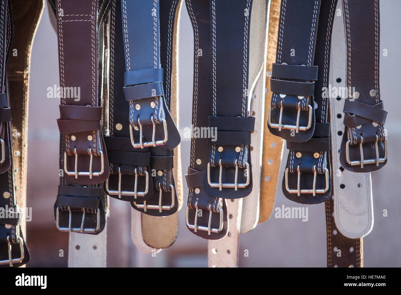 Color image of some leather belts on display. Stock Photo