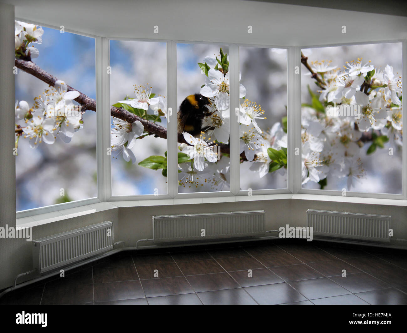 big windows with beautiful view of blooming garden beyond it Stock Photo