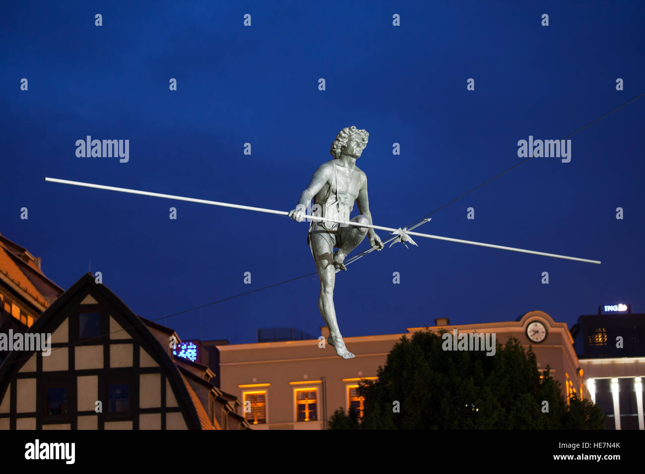 'Man crossing the River' at night, balancing sculpture by Jerzy Kedziora in Bydgoszcz, Poland, commemorates the Polish entry into the European Union Stock Photo