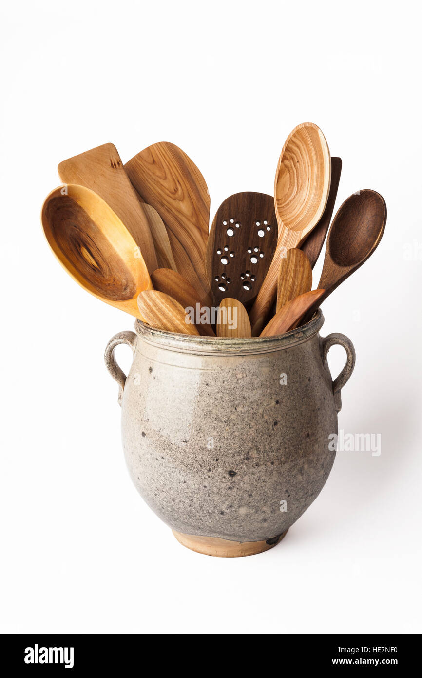Image of kitchen equipment : wooden spoon,knife in vintage clay pot Stock Photo