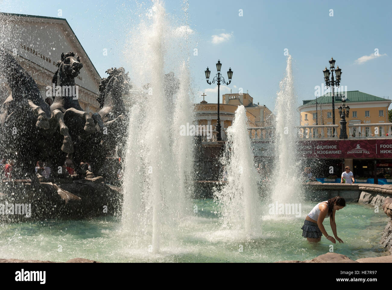 Young Muscovites playing in the fountain on Manezhnaya Square near Kremlin Stock Photo