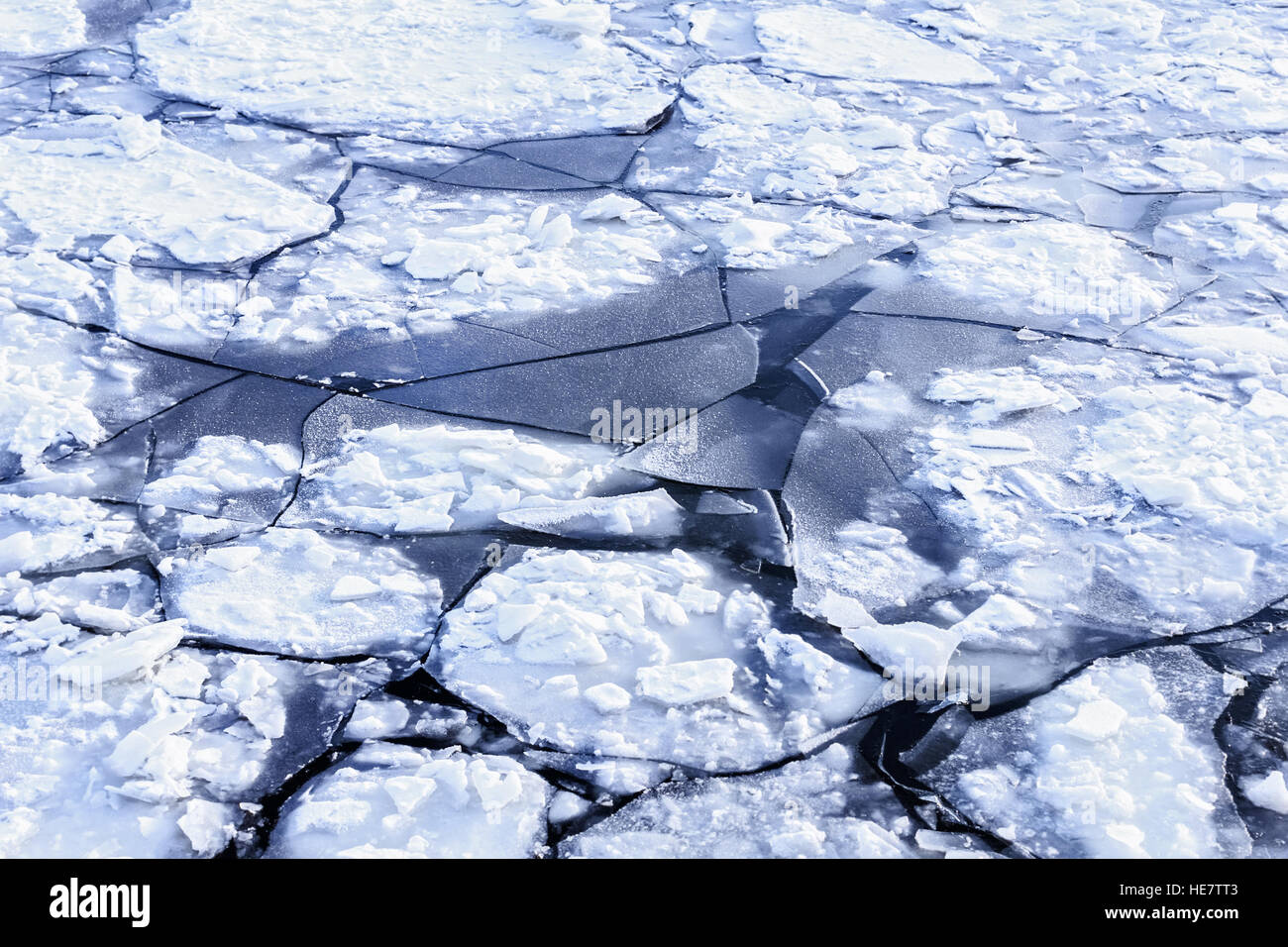 Big white ice in dark winter water Stock Photo