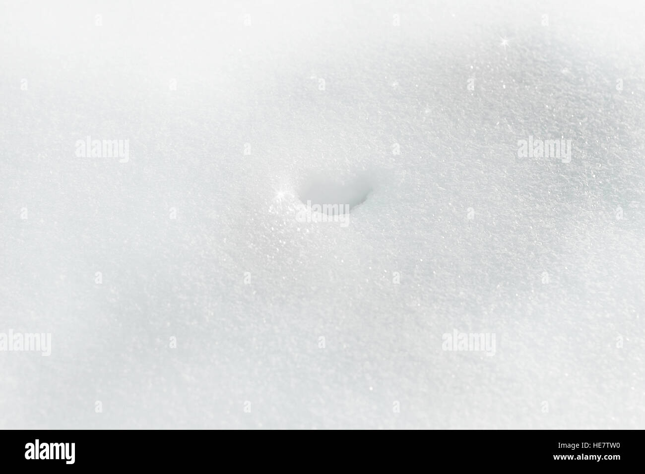 Hole in fresh winter snow as navel Stock Photo Alamy