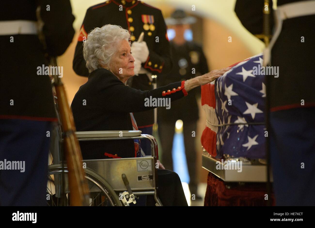 Annie Glenn, Widow of astronaut and former Senator John Glenn reaches out to touch the casket of her husband lying in repose at the Ohio State House December 16, 2016 in Columbus, Ohio. The former Marine pilot, Senator and first man to orbit the earth died last week at the age of 95. Stock Photo
