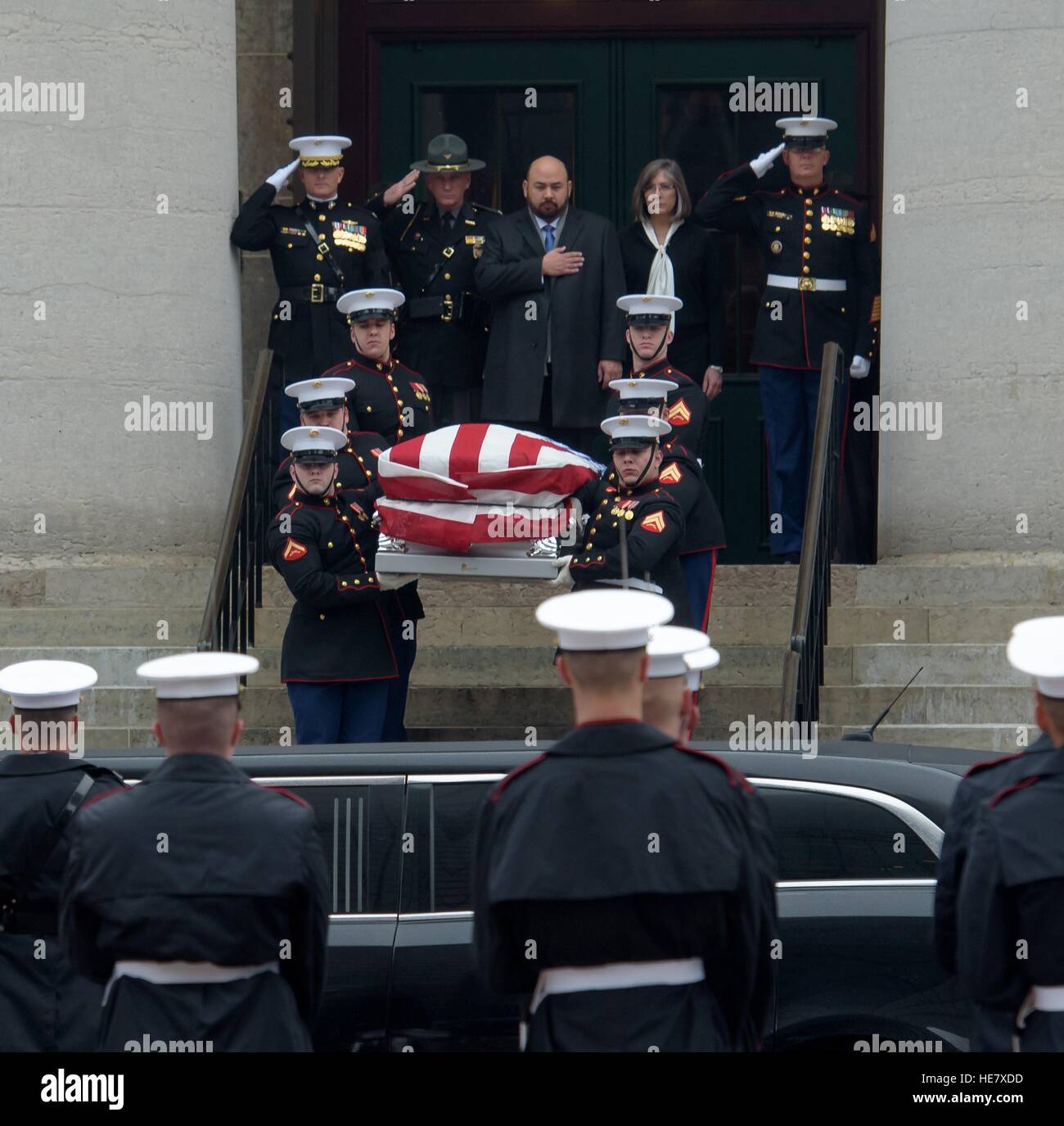 Speaker of the Ohio House Clifford Rosenberger, top center, puts his hand over his heart as the casket of astronaut and former Senator John Glenn is lead out of the Ohio Statehouse during the  funeral procession December 17, 2016 in Columbus, Ohio. The former Marine pilot, Senator and first man to orbit the earth died last week at the age of 95. Stock Photo