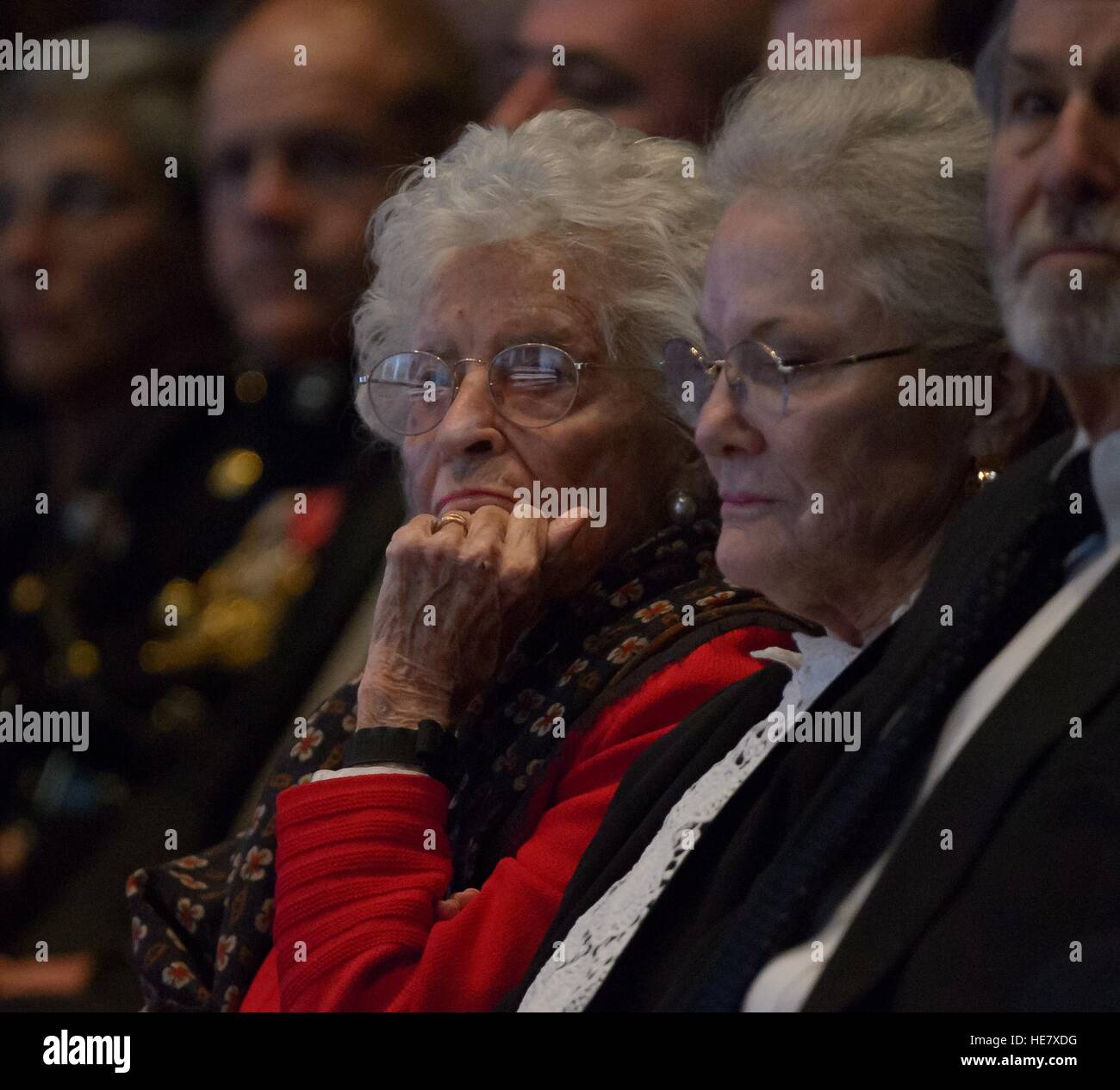 The flag draped casket of former astronaut and Senator John Glenn is reflected in the glasses of his wife Annie Glenn, as she and her daughter Lyn attend a ceremony celebrating his life at Ohio State University December 17, 2016 in Columbus, Ohio. The former Marine pilot, Senator and first man to orbit the earth died last week at the age of 95. Stock Photo