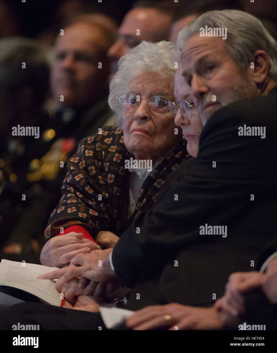 Annie Glenn, Widow of former astronaut and Senator John Glenn, left, Glen's daughter Lyn, and Pock Otis hold hands during a service celebrating his life at Ohio State University December 17, 2016 in Columbus, Ohio. The former Marine pilot, Senator and first man to orbit the earth died last week at the age of 95. Stock Photo