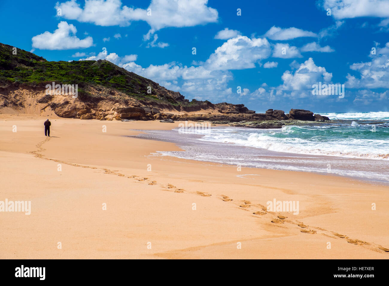 Coastal scenery on The Great Ocean Road in the Australian state of Victoria, with a lone figure on beach Stock Photo