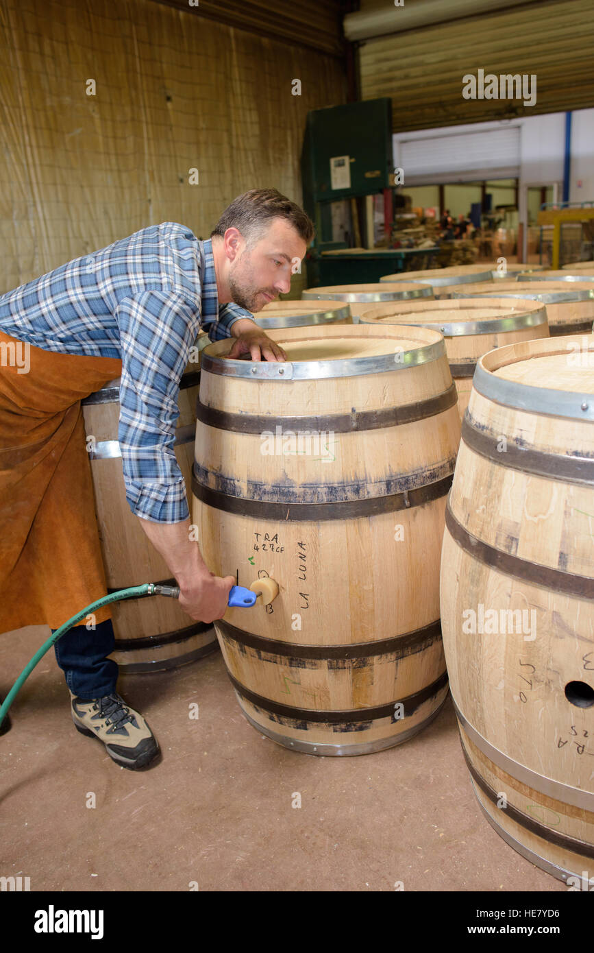 wood barrels production cooper using hammer and tools in workshop Stock ...