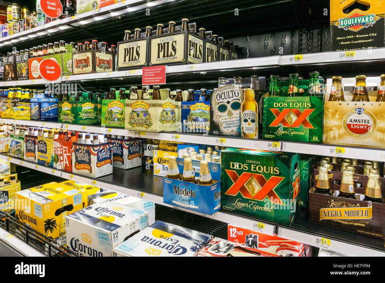 Varieties of bottled beer for sale in a supermarket. Stock Photo
