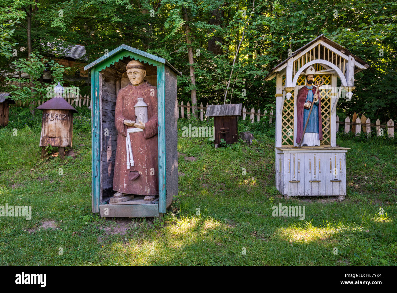 Beehives in shape of monk, with statue of bishop, apiary, Pogorzanie ethnic group, Rural Architecture Museum in Sanok, Poland Stock Photo
