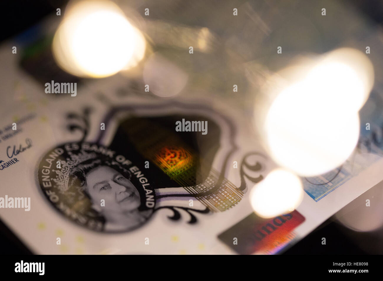 Close up of the new 2016 polymer five pound note with blurred lights in foreground. Stock Photo