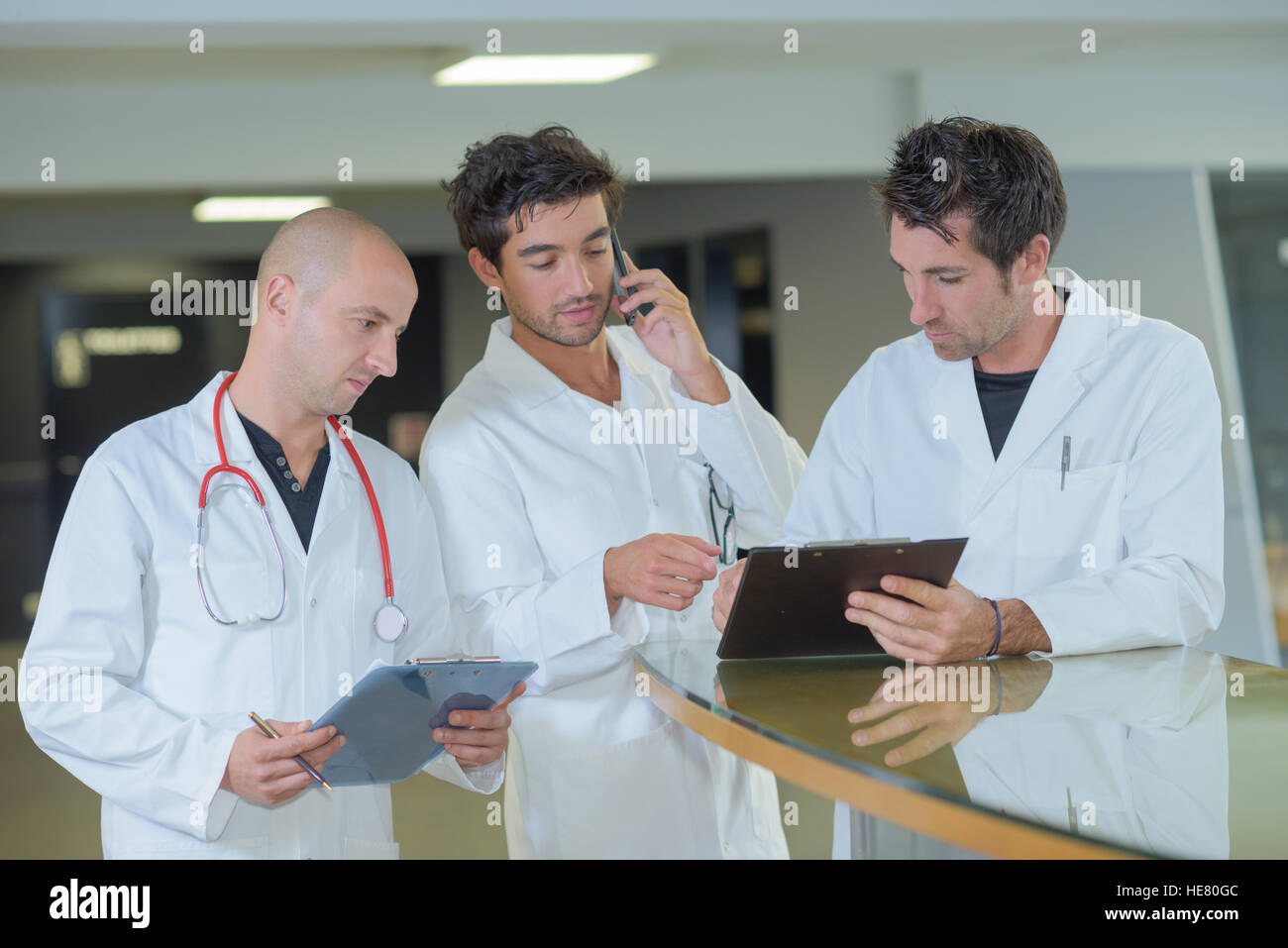 Three medics in discussion Stock Photo - Alamy