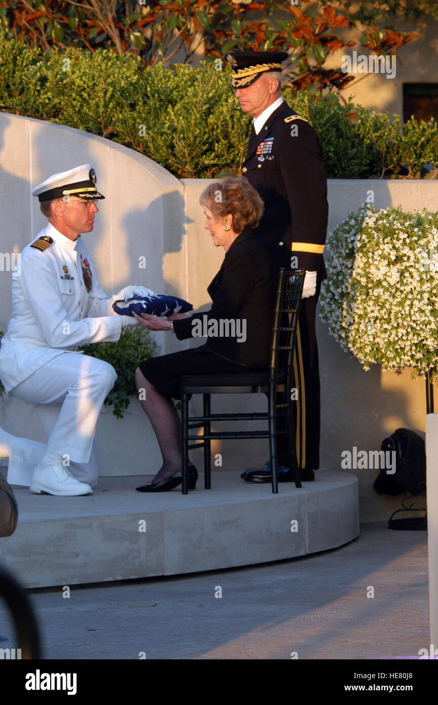 U.S. Navy officers present former U.S. First Lady Nancy Reagan with the casket flag during internment services for former U.S. President Ronald Reagan at the Ronald Reagan Presidential Library June 11, 2004 in Simi Valley, California. Stock Photo