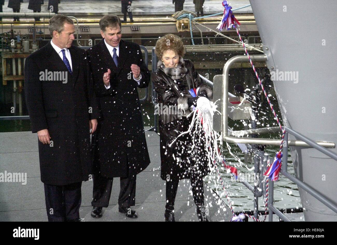 U.S. President George W. Bush and Newport News Shipbuilding President and CEO William Frick watch former First Lady Nancy Reagan christen the new USN Nimitz-class nuclear-powered aircraft carrier USS Ronald Reagan at the Northrop Grumman Newport News Shipbuilding facility March 4, 2001 in Newport News, Virginia. Stock Photo