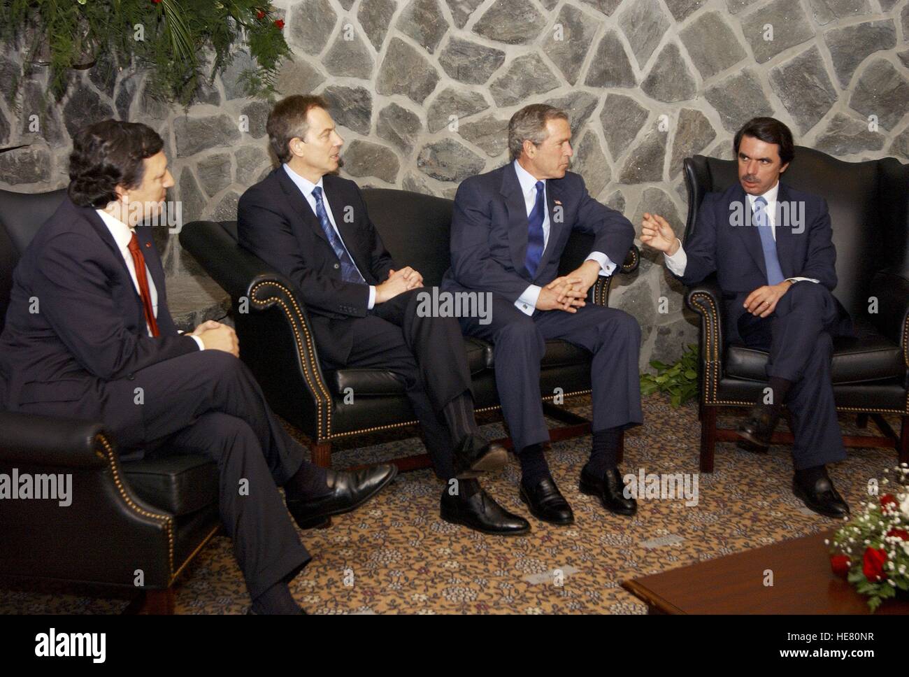 Portuguese Prime Minister Jose Manuel Durao Barroso, British Prime Minister Tony Blair, U.S. President George W. Bush, and Spanish Prime Minister Jose Maria Aznar discuss a possible war in Iraq during an emergency summit March 16, 2003 in the Azores in Portugal. Stock Photo