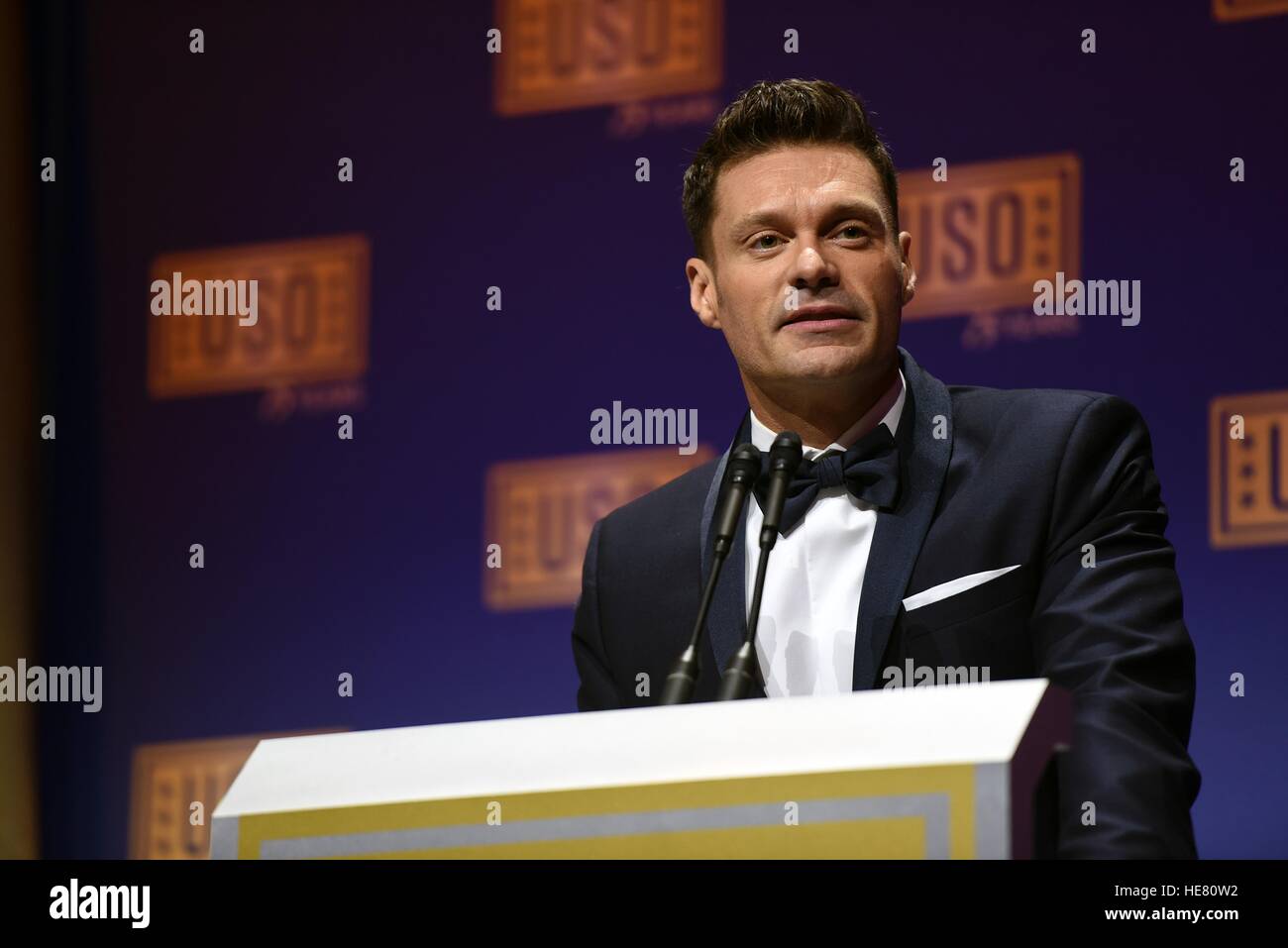 Television and radio personality Ryan Seacrest hosts the USO Gala at the Daughters of the American Revolution Constitution Hall October 20, 2016 in Washington, DC. Stock Photo