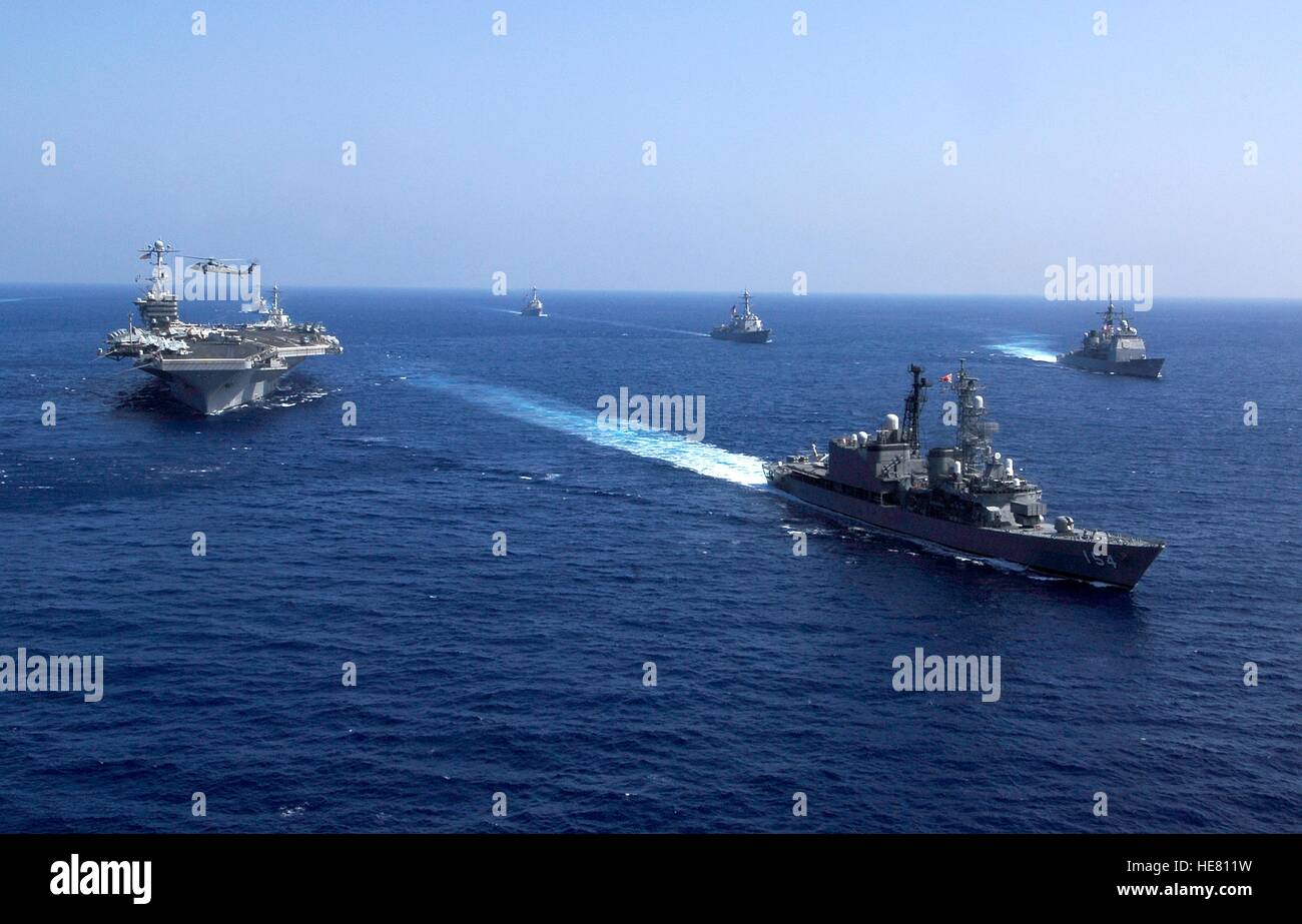 U.S. and Japanese ships steam in formation alongside the USN Nimitz-class aircraft carrier USS John C. Stennis after completing the Under Sea Warfare Exercise February 12, 2009 in the Pacific Ocean. Stock Photo