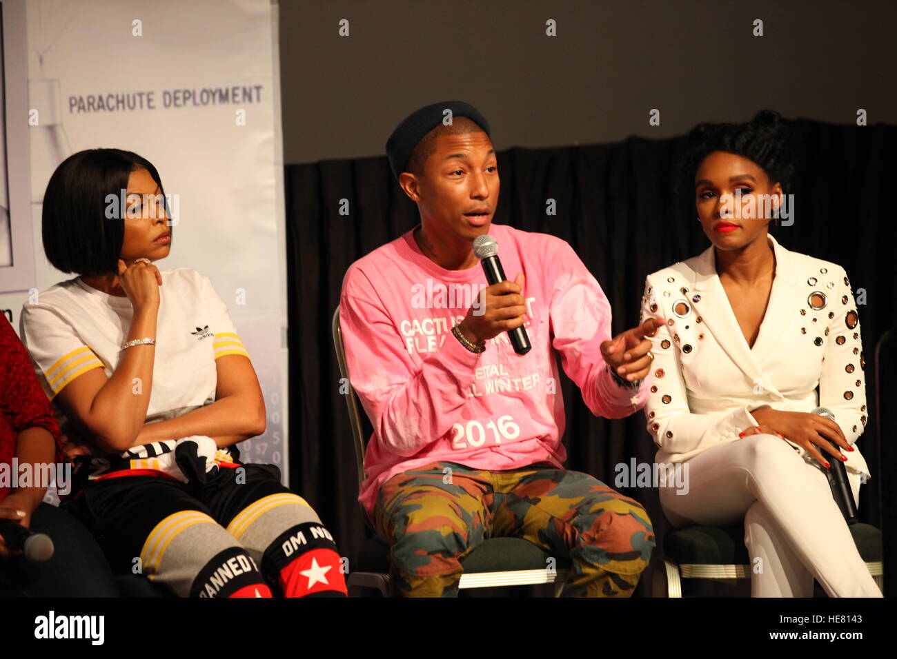 Cast and crew members of the upcoming film Hidden Figures (L-R) actress Taraji P. Henson, musician Pharrell Williams, and actress Janelle Monae participate in a question and answer session about the film at the Kennedy Space Center Visitor Complex IMAX Theater December 12, 2016 in Merritt Island, Florida. The film is based on the African-American women who worked on the NASA Project Mercury missions in 1962. Stock Photo