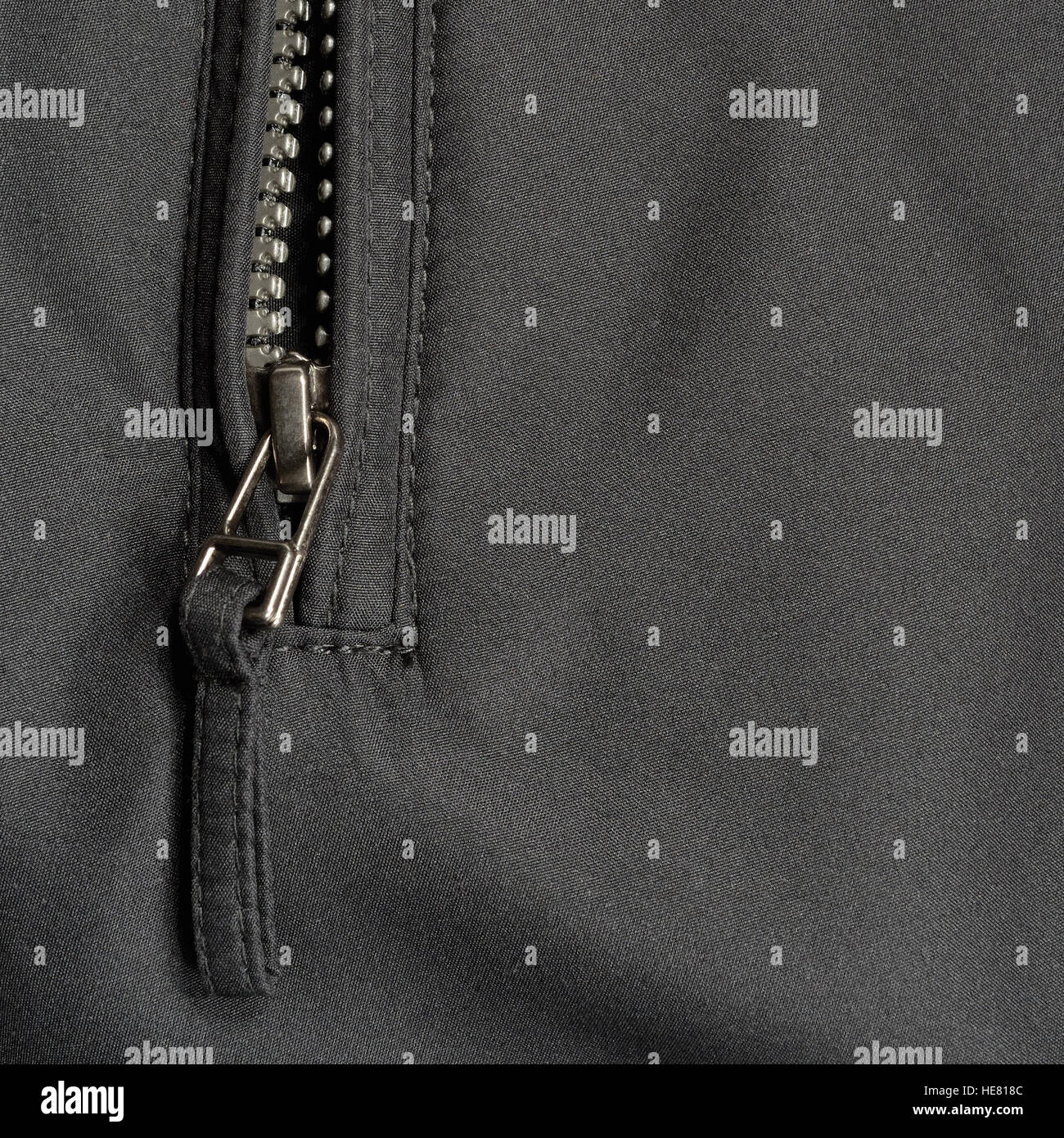 Black polyester twill fabric texture background, open jacket zipper pull detail, textured textile, macro closeup, large detailed Stock Photo