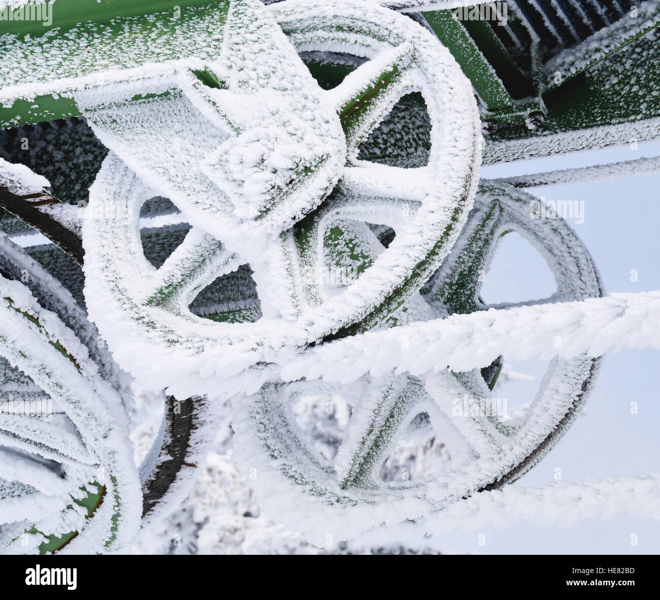 Frozen metal wheel covered in ice and snow Stock Photo Alamy