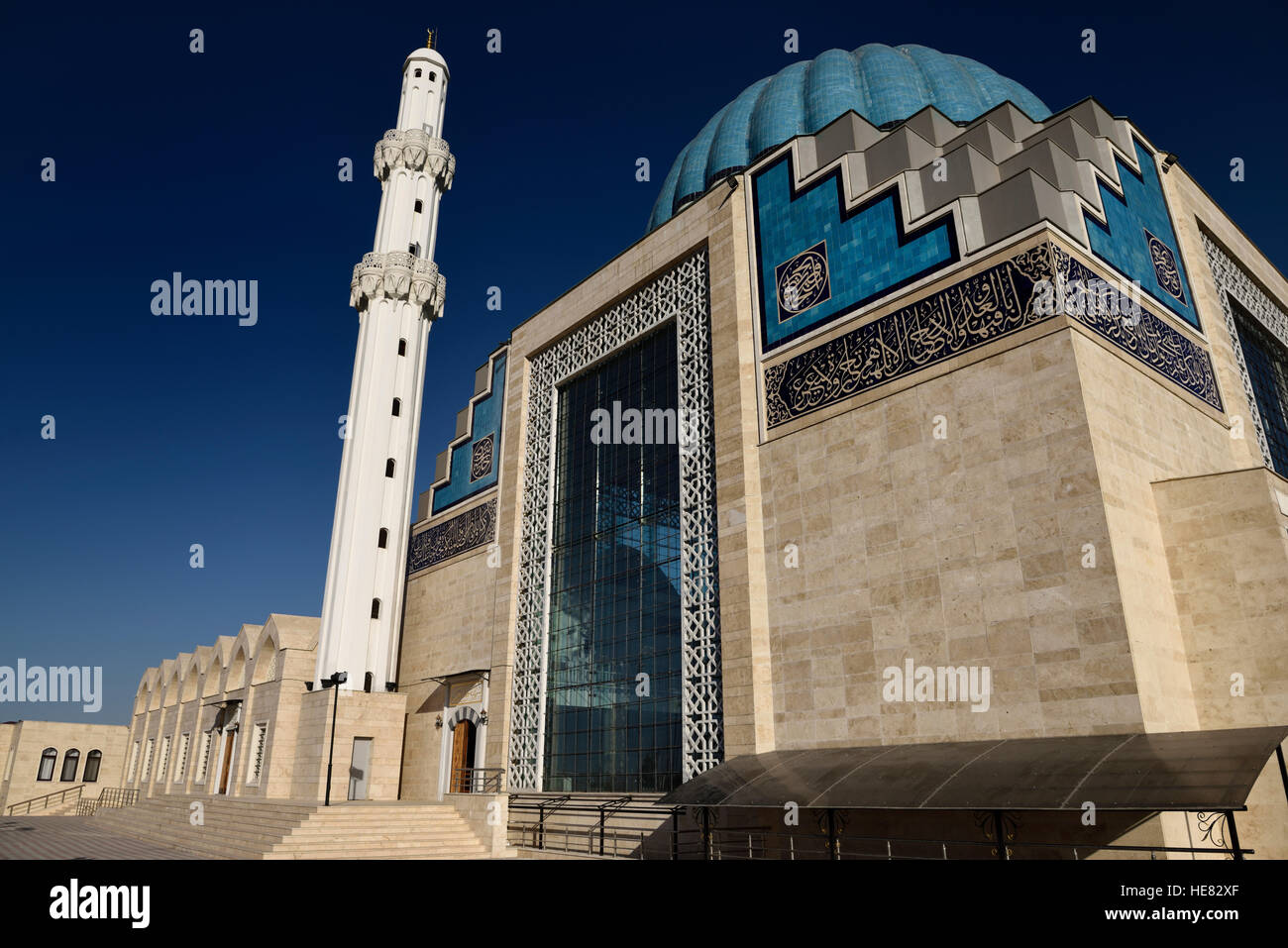 Blue sky and white minaret of modern Hoca Ahmet Yesevi Mosque in Turkistan Kazakhstan Stock Photo