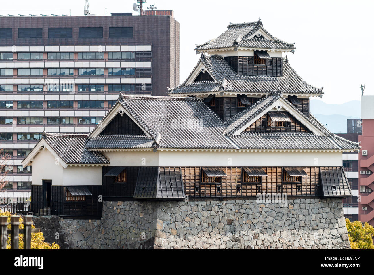 Kumamoto castle, Ginnan-jo. Five-storey Iidamaru Go-kai yagura, turret with city hotel block behind, before damaged caused by 2016 earthquake. Stock Photo