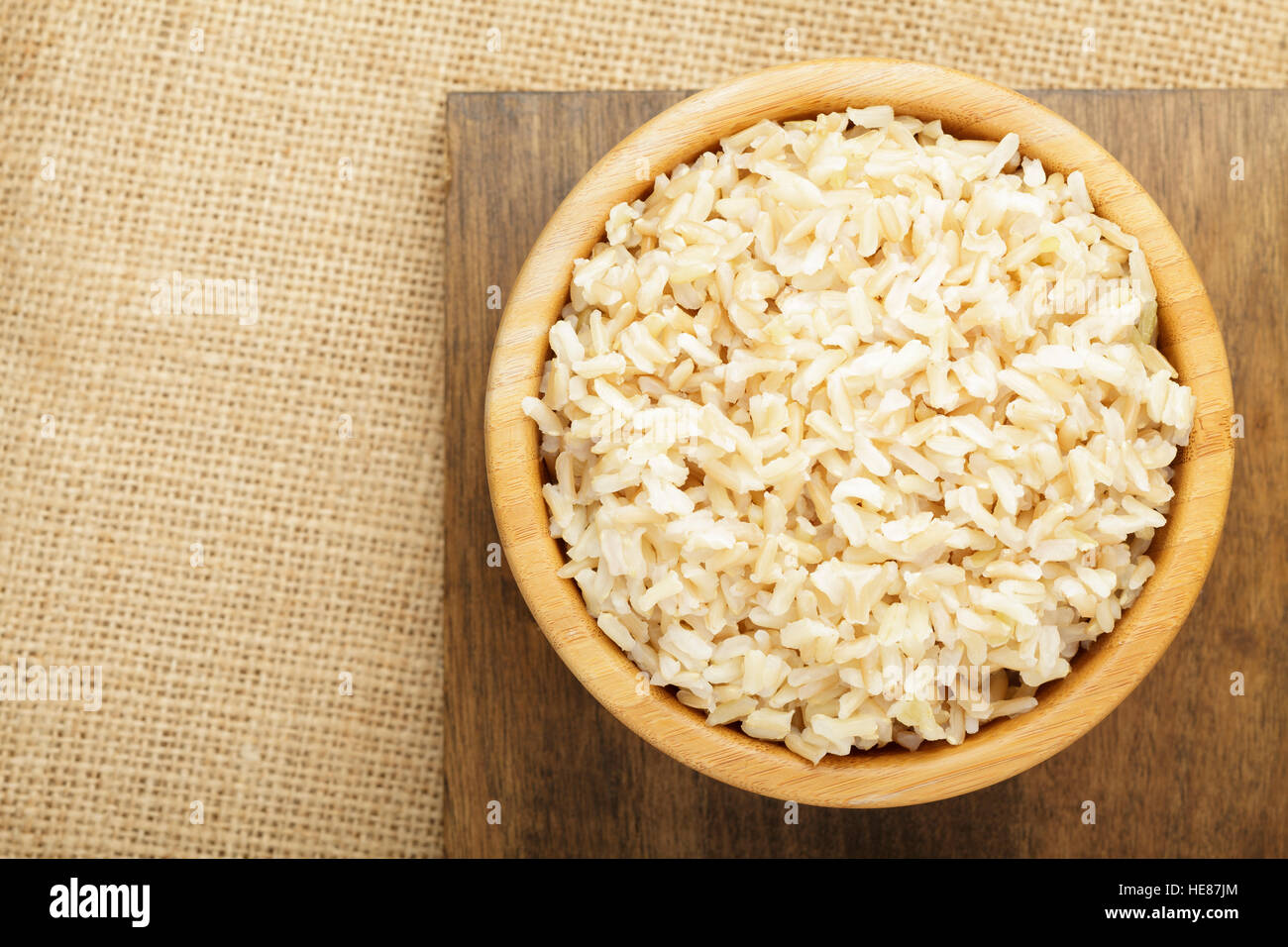 Brown rice in wooden bowl, cooked Stock Photo