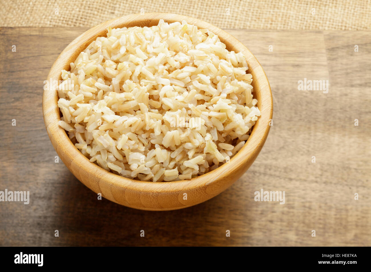 Brown rice in wooden bowl, cooked Stock Photo
