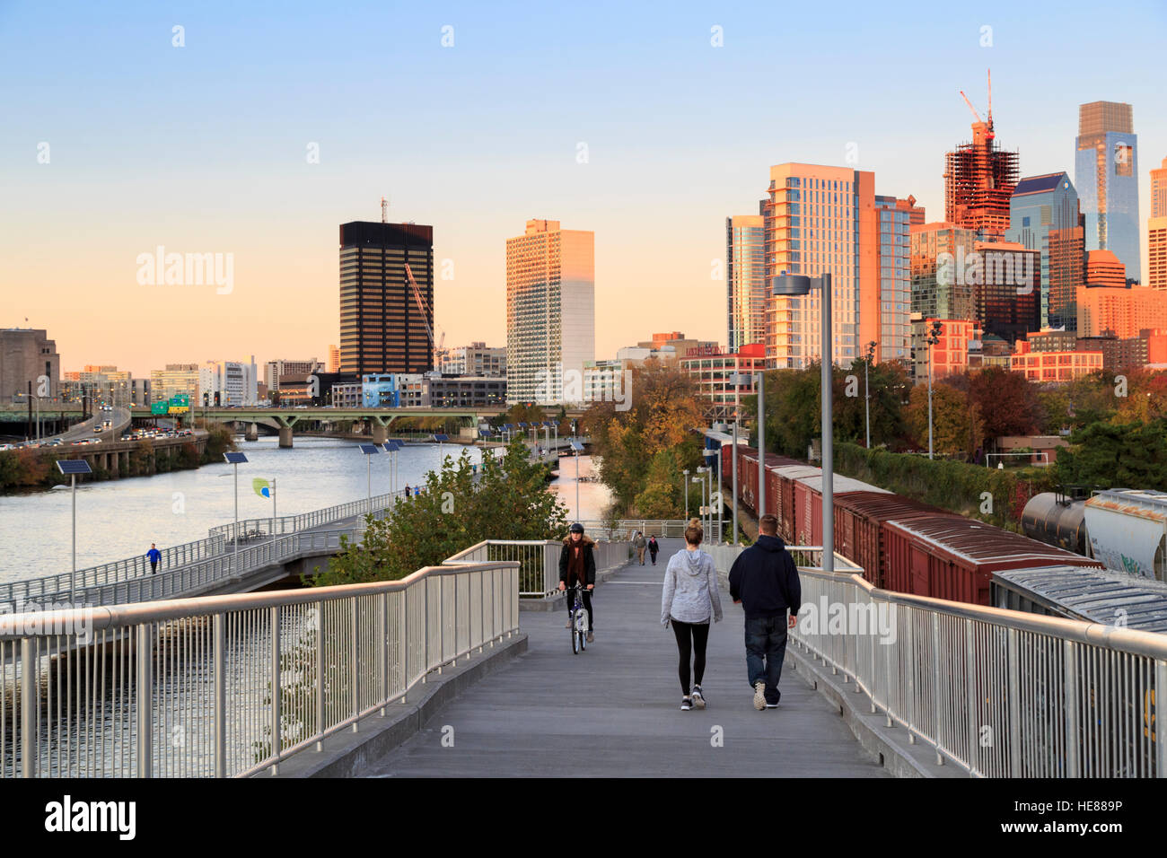Pedestrians on the Schuylkill River Trail Boardwalk at sunset, Philadelphia, Pennsylvania, USA Stock Photo