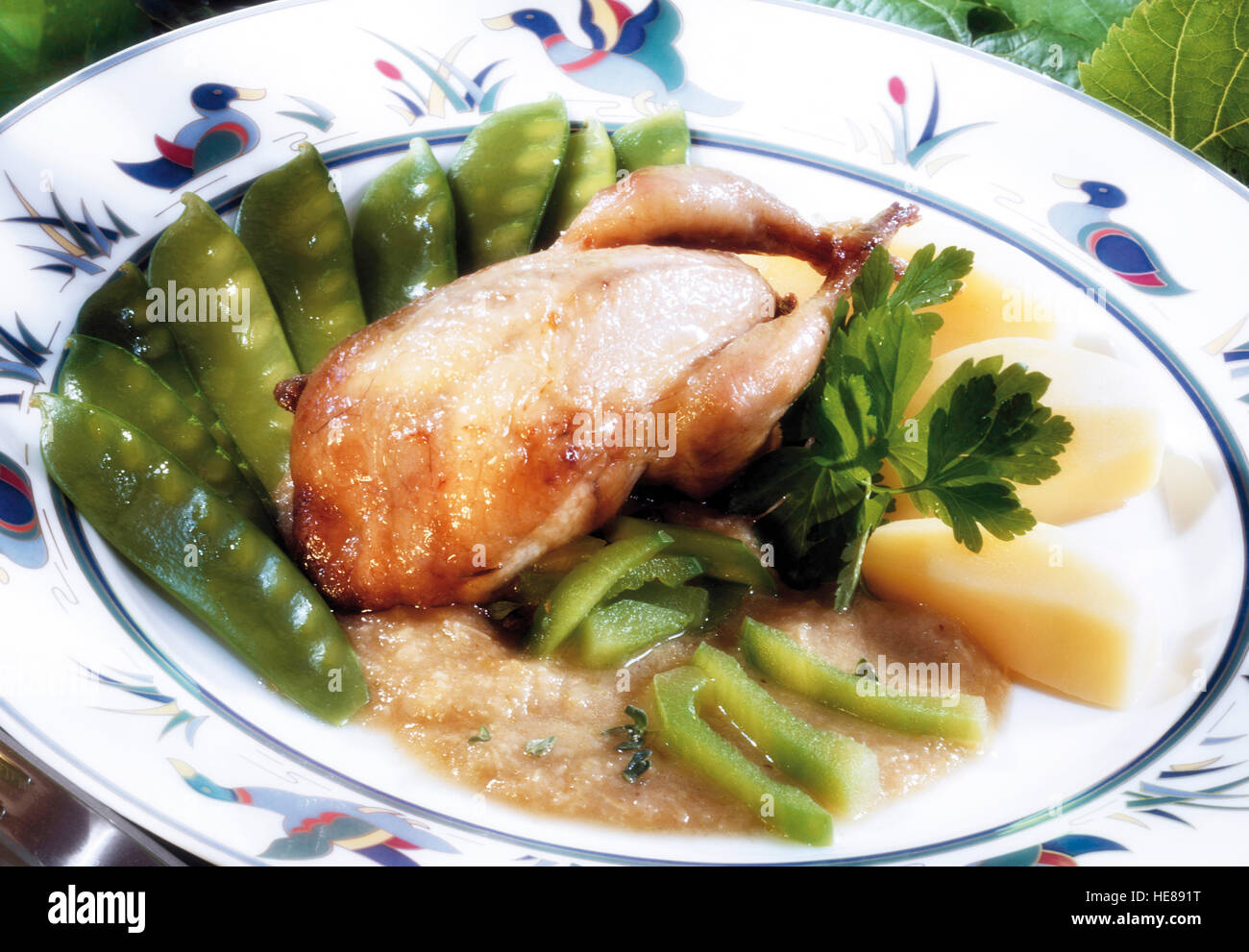Fried partridge with sugar peas and celery Stock Photo