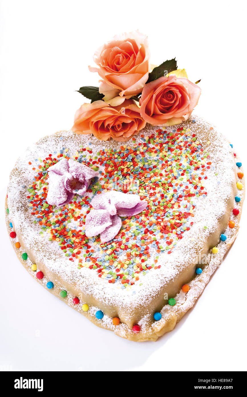 Heart shaped cake covered with marzipan, adorned with roses Stock Photo