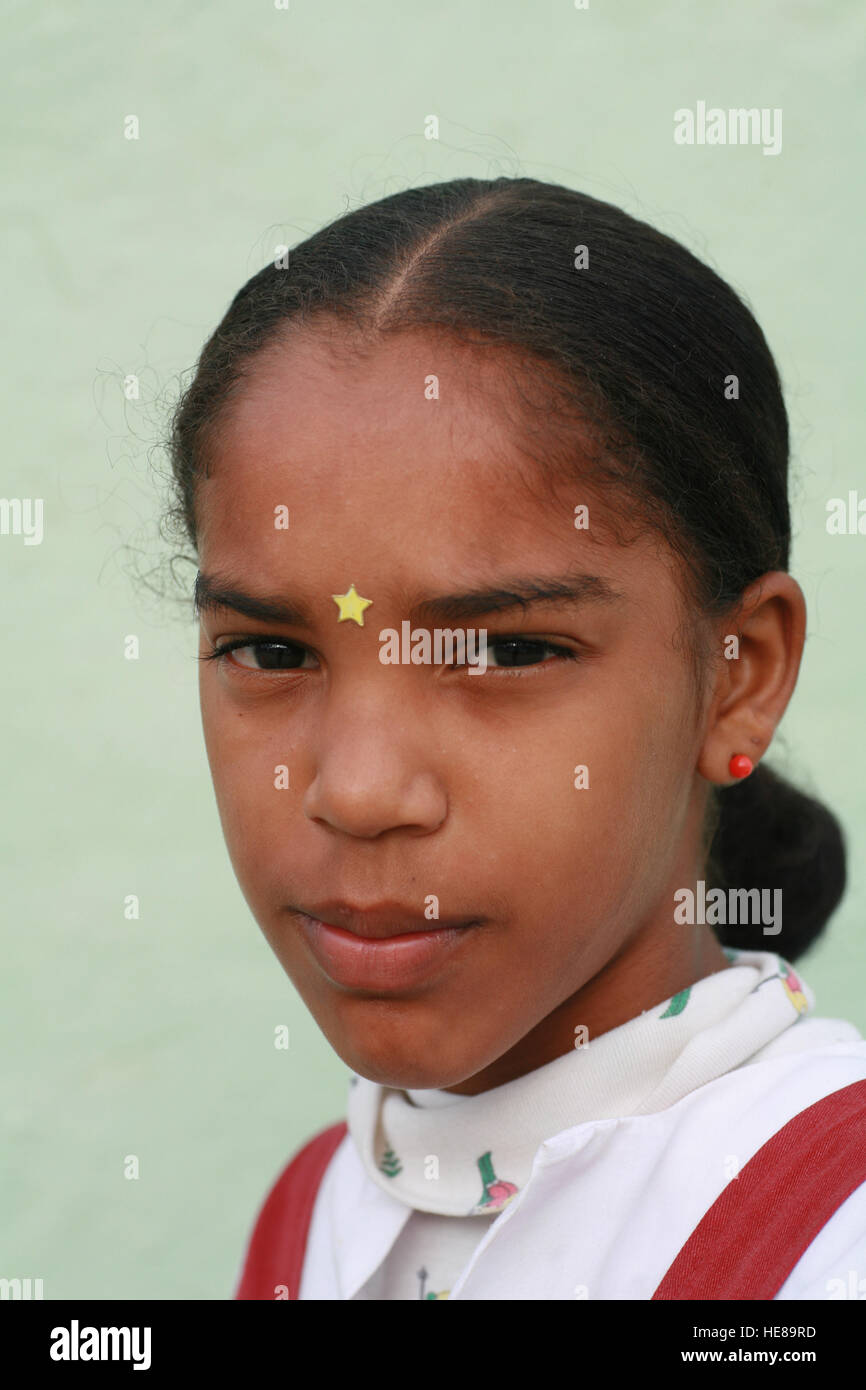 Schoolgirl wearing a gold star on her forehead, Trinidad, Sancti-Spiritus Province, Cuba, Latin America Stock Photo