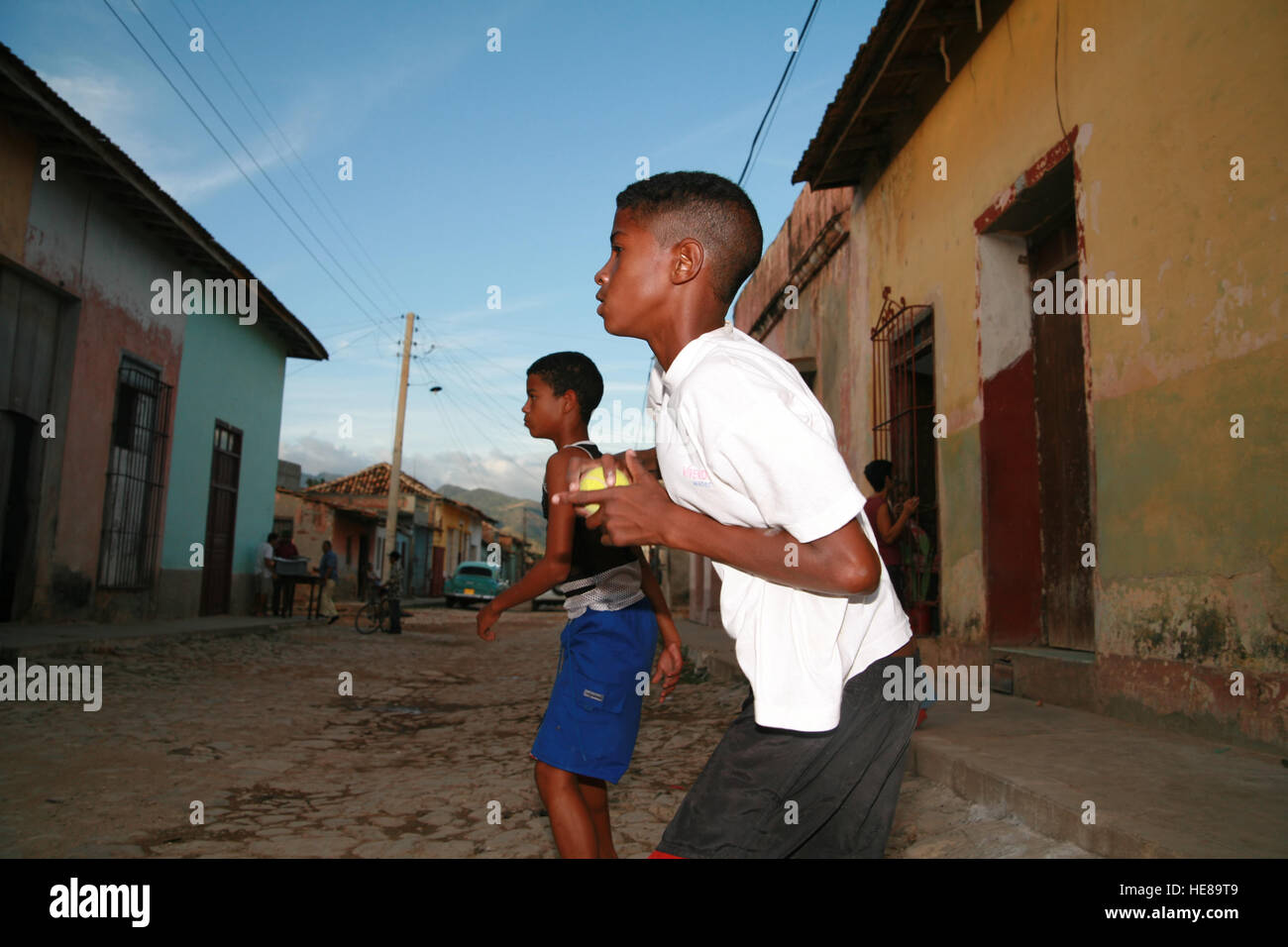 Children playing baseball on a street in Trinidad, Sancti-Spíritus Province, Cuba, Latin America Stock Photo