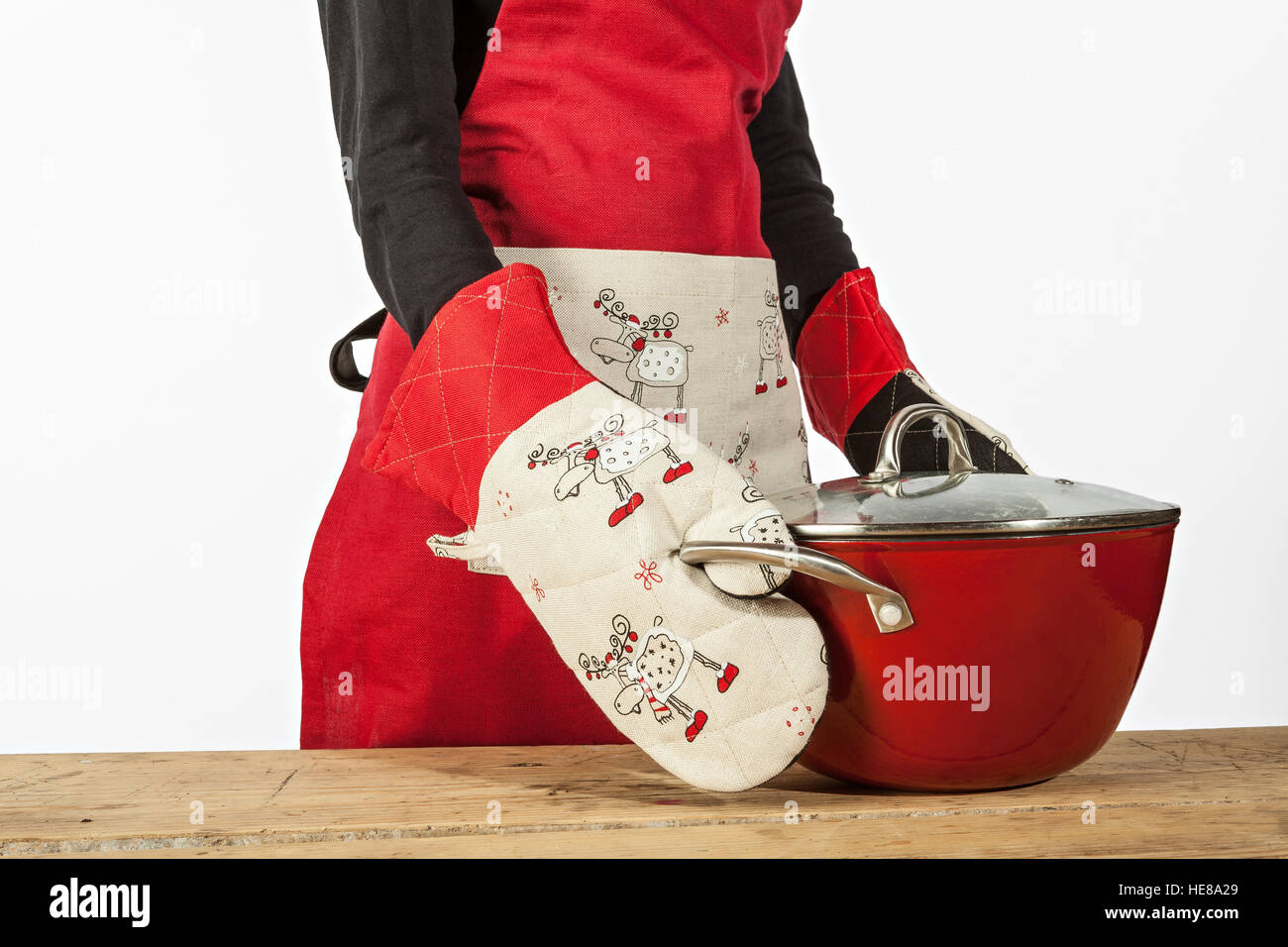 Woman with gloves and apron making Christmas dish Stock Photo