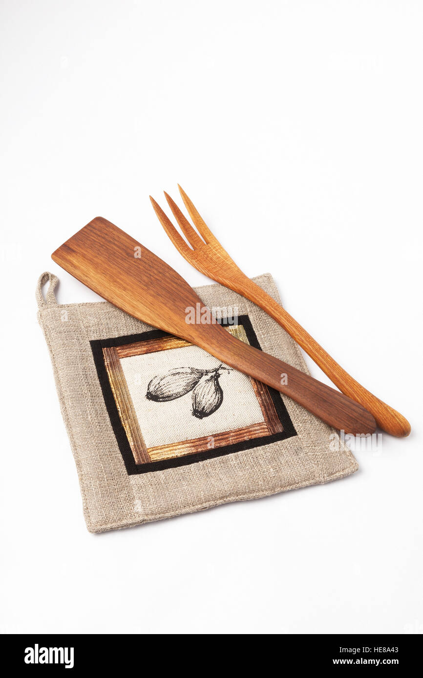 Kitchen utensils - linen potholder, wooden tools isolated on white. Stock Photo