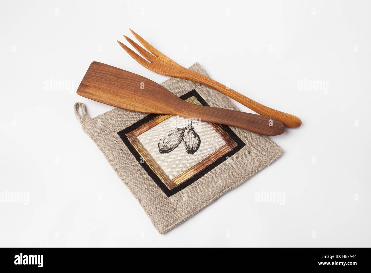 Kitchen utensils - linen potholder, wooden tools isolated on white Stock Photo