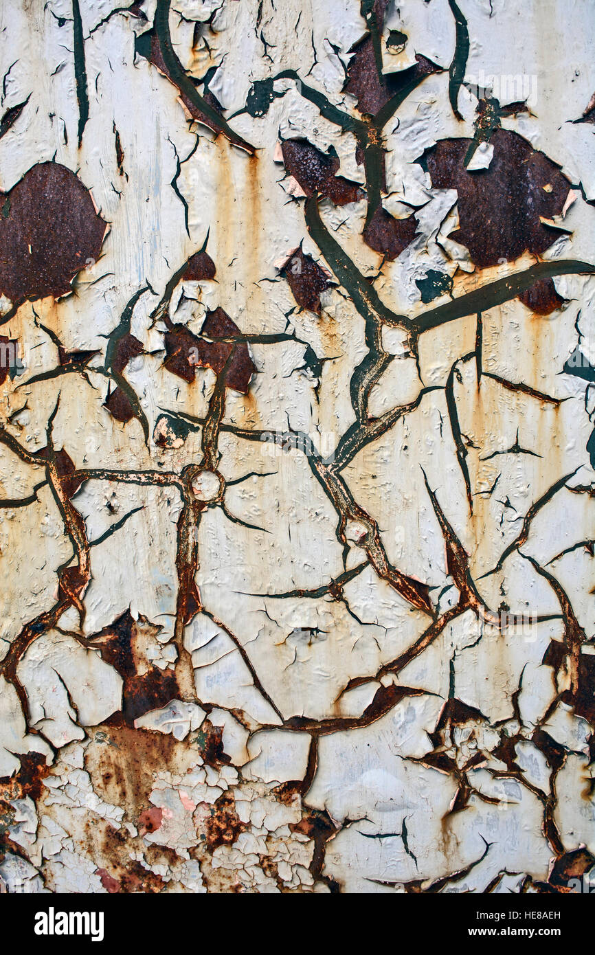 Old and damaged, cracked paint on tin surfaces. Stock Photo