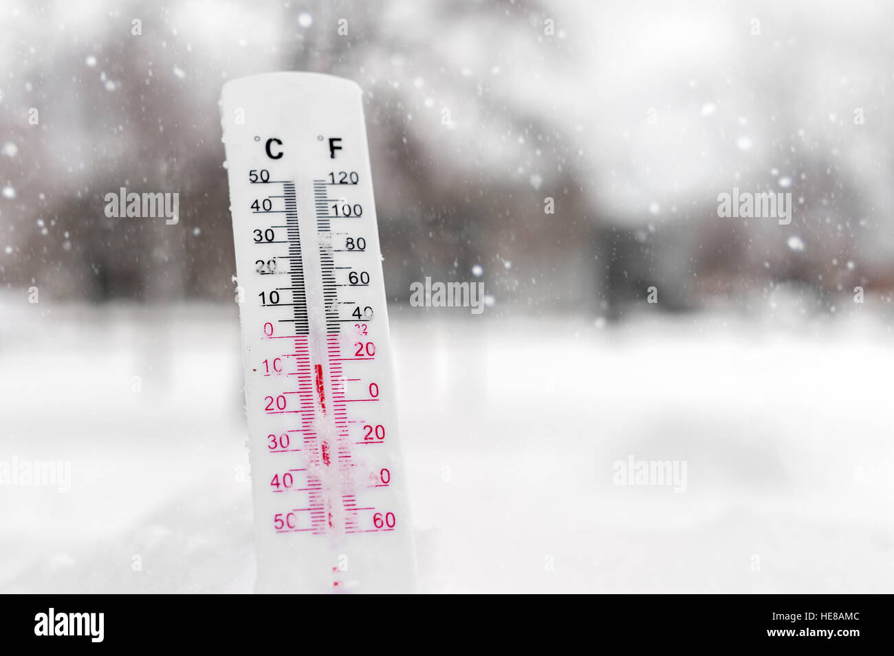 Thermometer on snow showing very low temperature Stock Photo