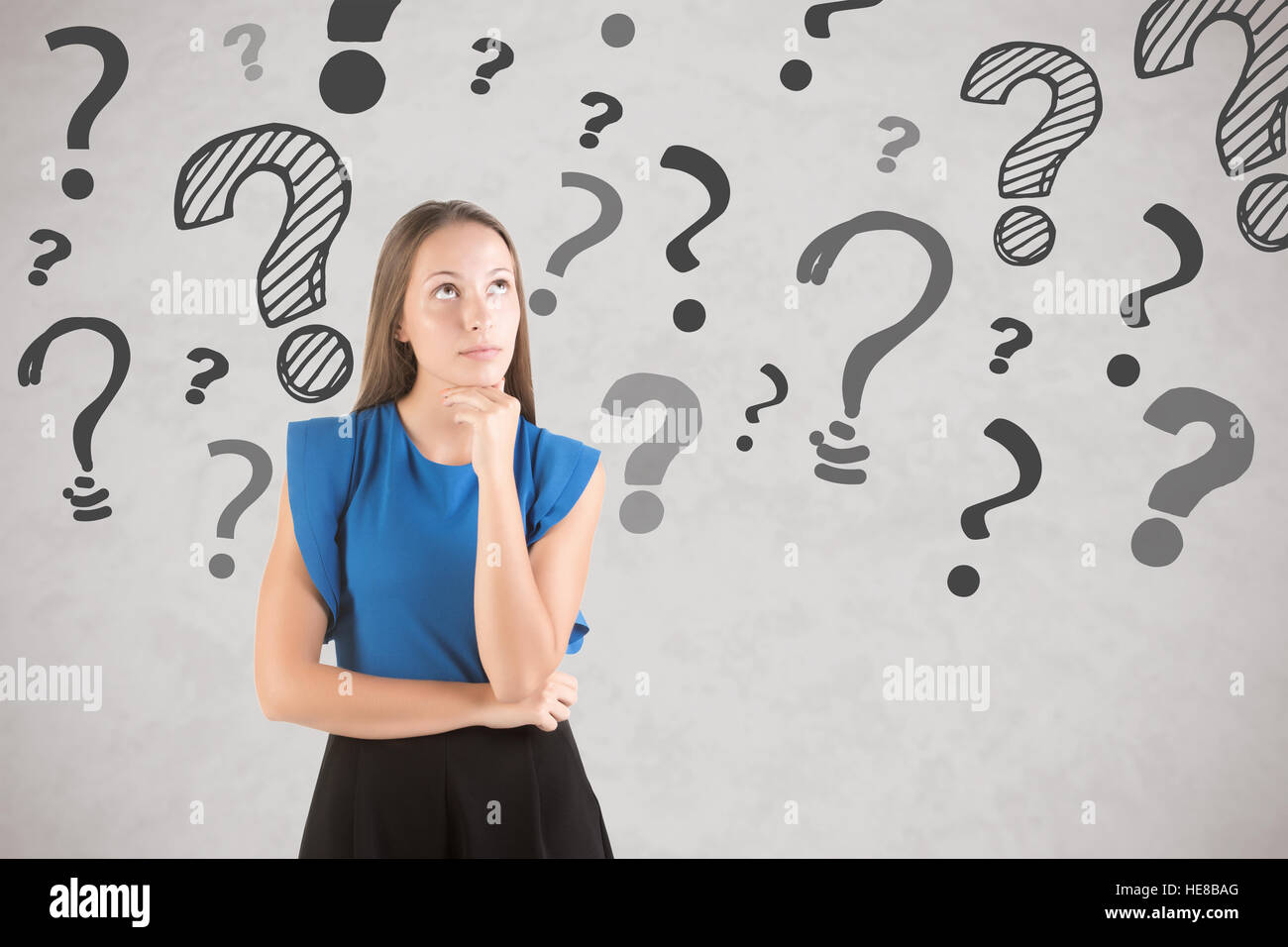 Woman thinking in a white background with a question marks around her Stock Photo