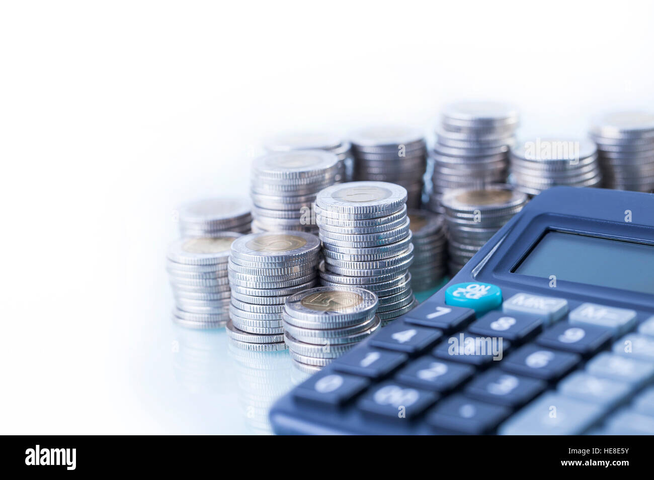 counting pile of money, calculator in white background Stock