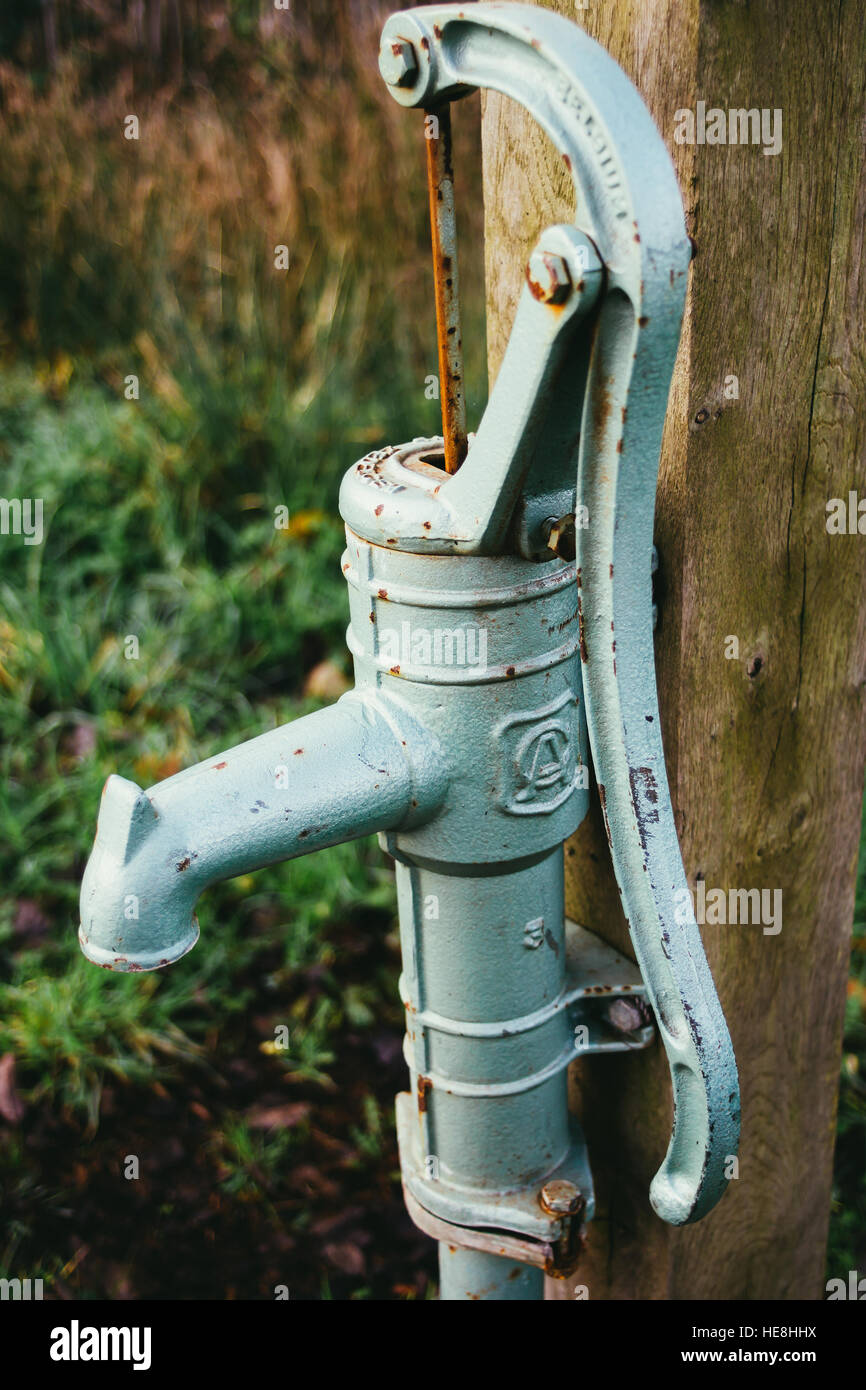 A closeup on an old vintage water pump outdoors. Stock Photo