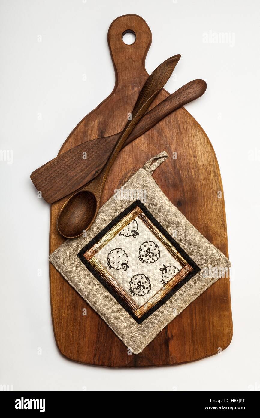 Kitchen equipment - wooden cutting table,tools and linen patchwork potholder Stock Photo